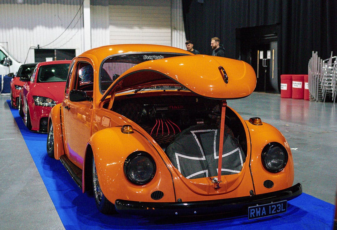 Orange 1970s VW beetle vehicle featured at Ultimate Dubs UK 2024 with Air Lift Performance 